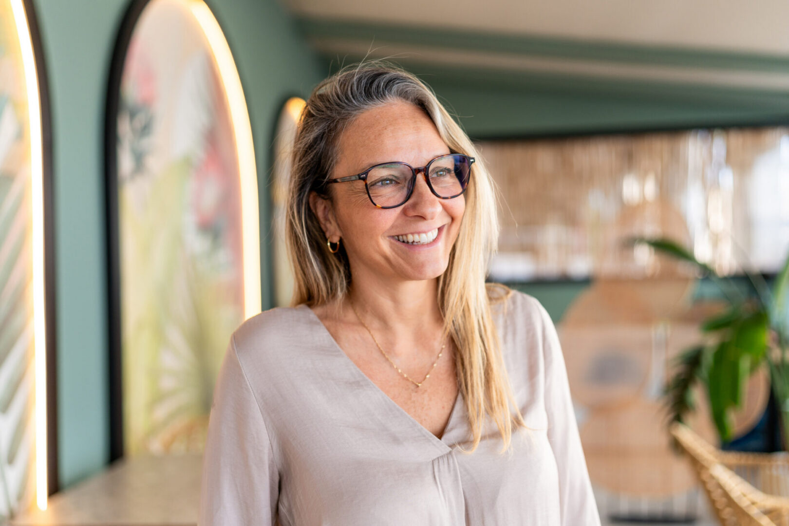 Smiling woman wearing glasses in cafe